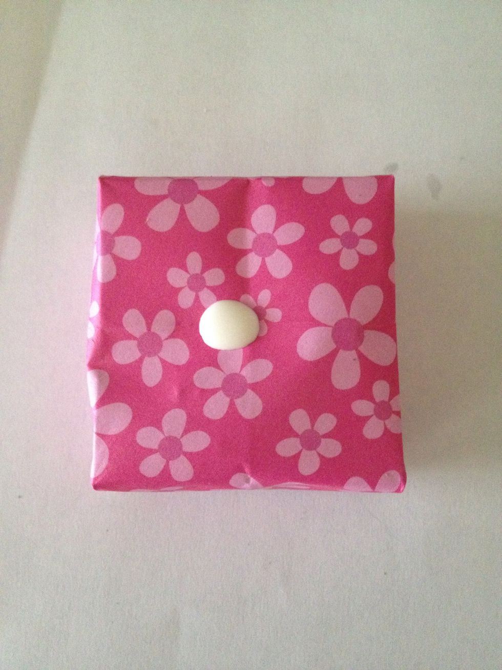 Dab glue onto where you want your handle. I am putting this one on top of an origami box I made.