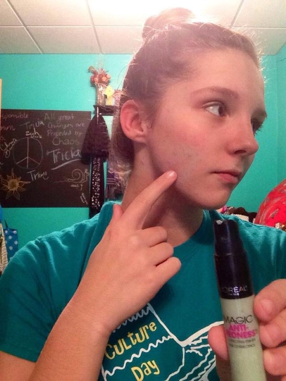 Dab green color corrector over any red blemishes with your clean finger.