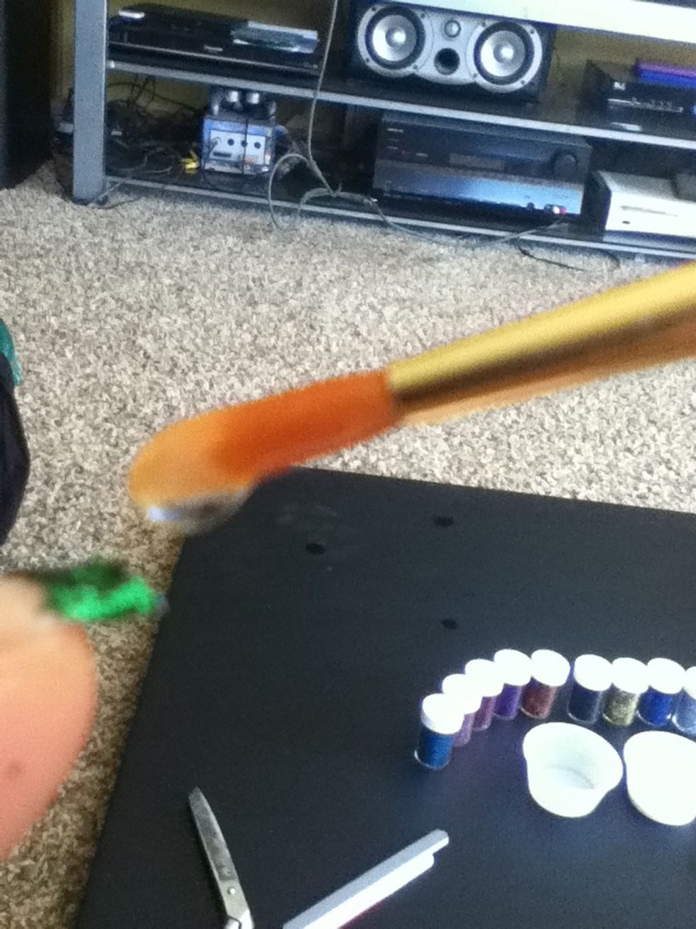Dab more glue on the tip of your nail where the glitter is