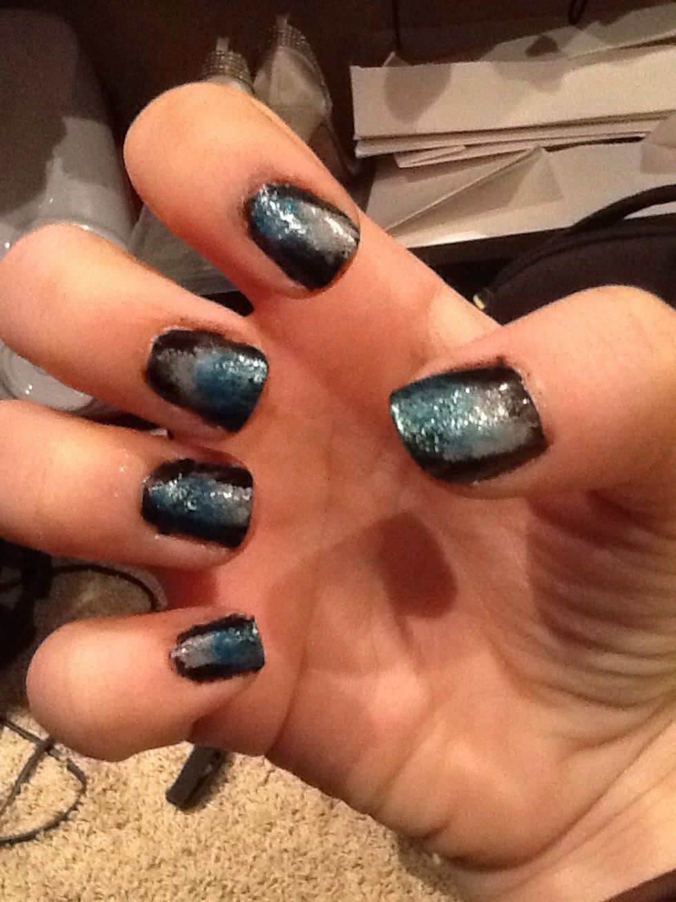 Dab the blue nail polish that is on the sponge onto your nails, on top of the grey but only on half of it.