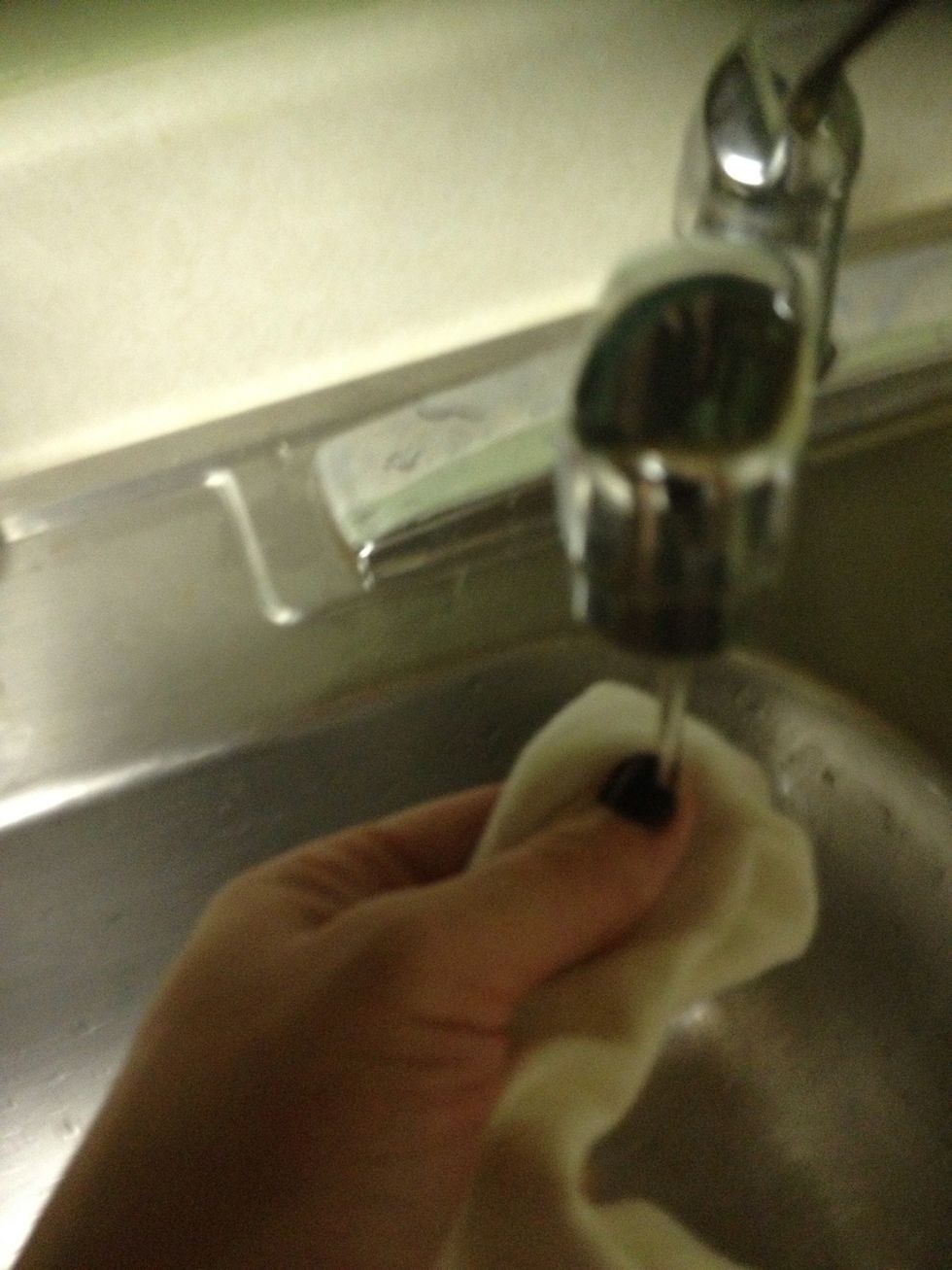Dampen a clean dish rag.