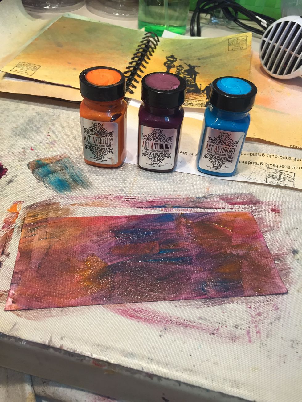 Dampen a piece of Bristol (or watercolor) paper and paint on layers of Tango, Figi, and Wineberry Velvet.  Blend.