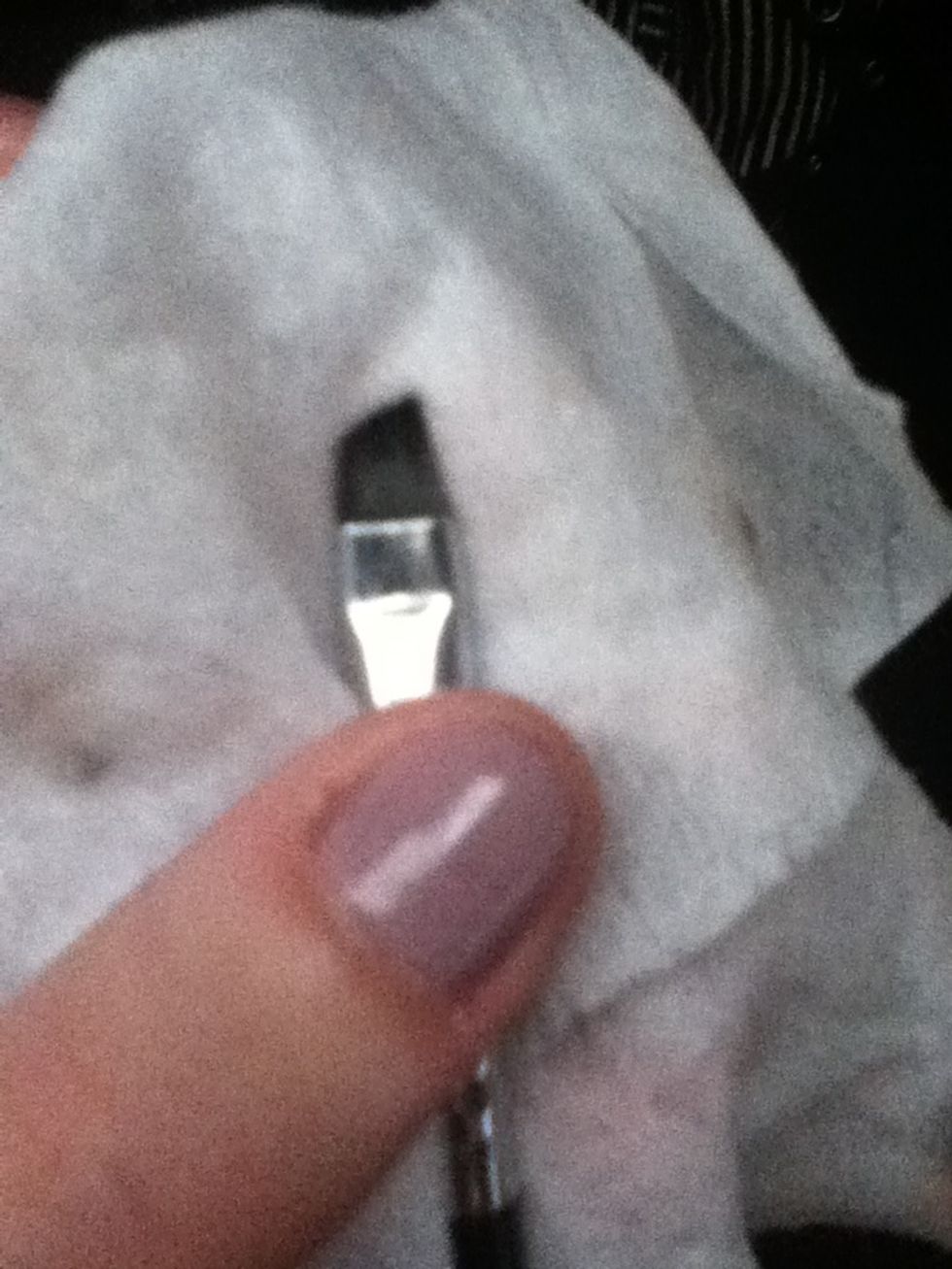 Dampen angled eyeliner brush.