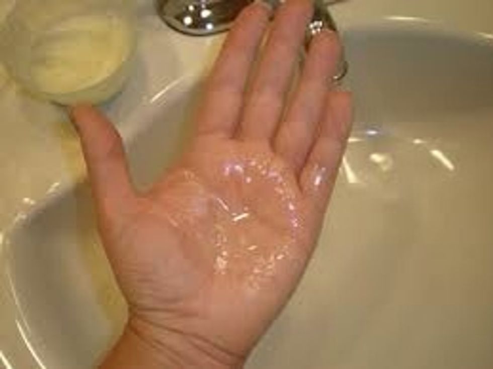 Dampen your hair with warm water over a sink. Take a quarter size of coconut oil and massage in your hand. It melts easily from your body heat. I put a bowl in the microwave for 20 seconds to melt.