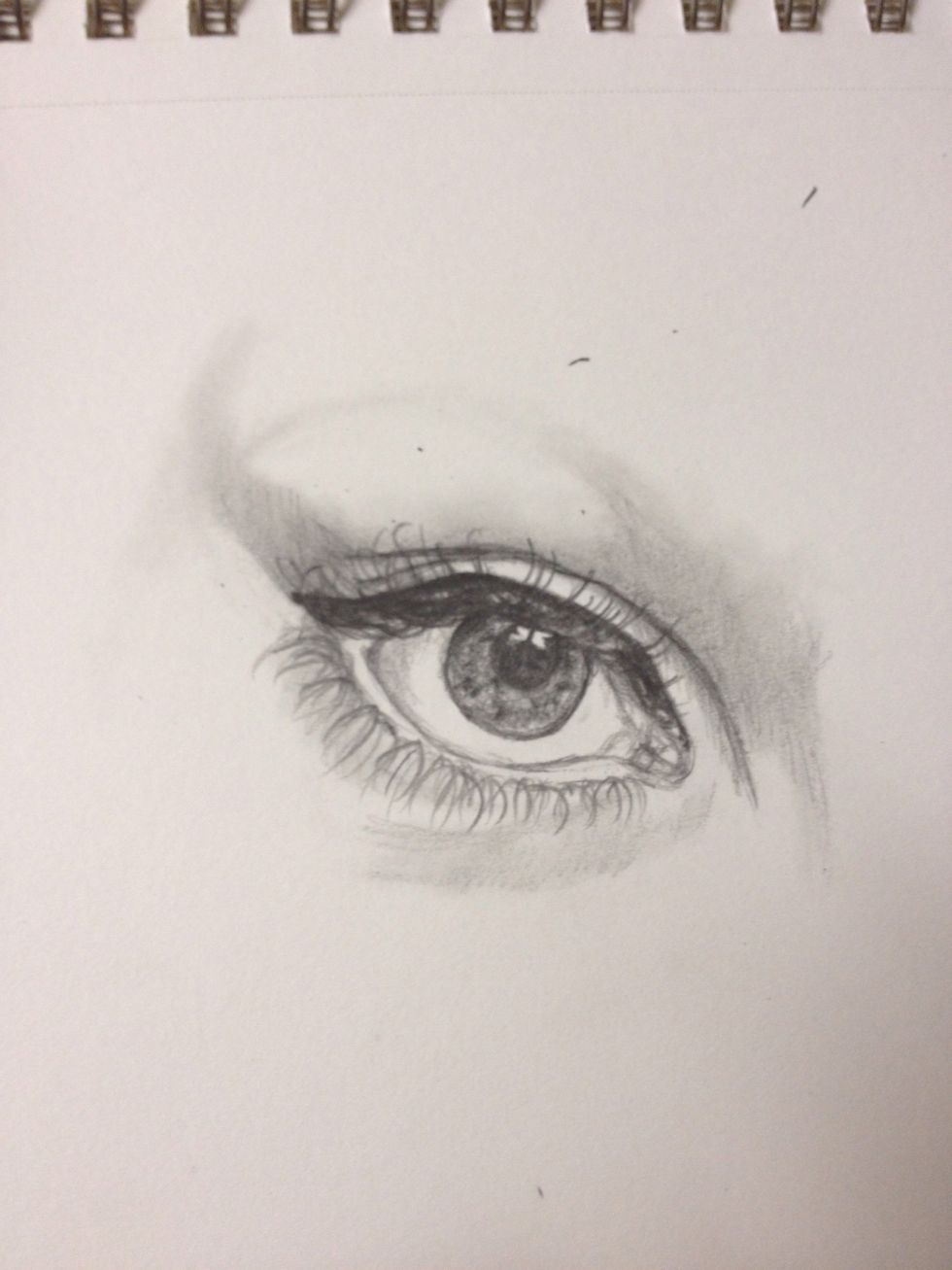 Darken any crease line created and run the q-tip to smudge. Shade the eyeball itself by lightly running the q-tip in the corners. I planned out where the eyebrow will be with the q-tip.