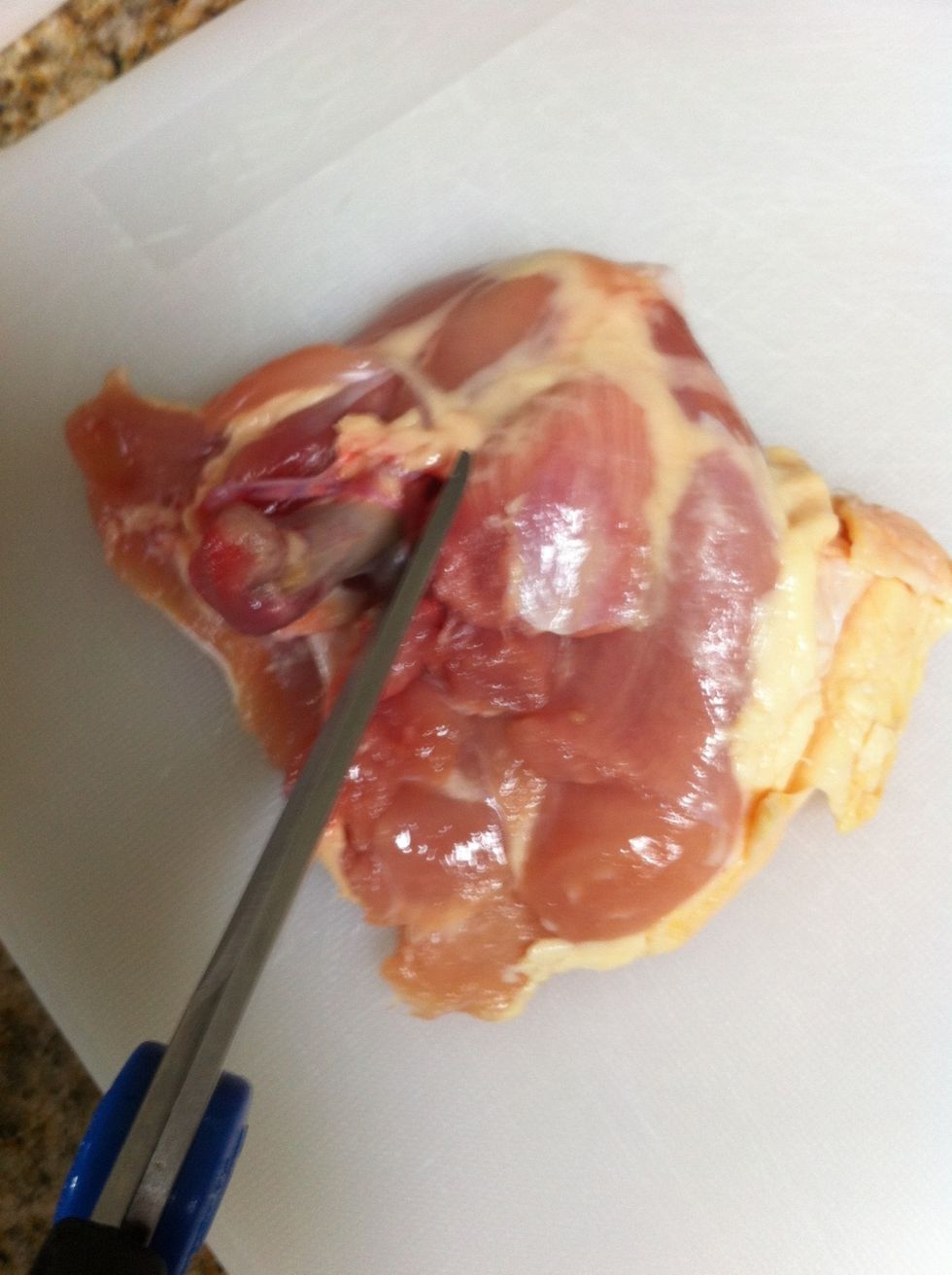 De-bone chicken thigh with scissors. Cut off some excess fat while you're at it, too.