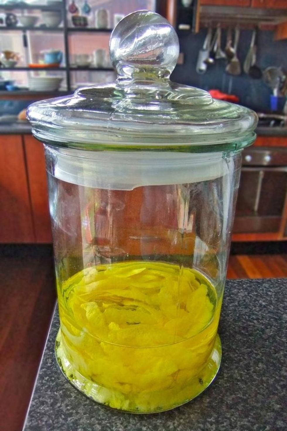 De-skin the lemons and place in a large container. Pour the 98% proof booze over the top and leave for 40 days and nights, shaking/ mixing occasionally.