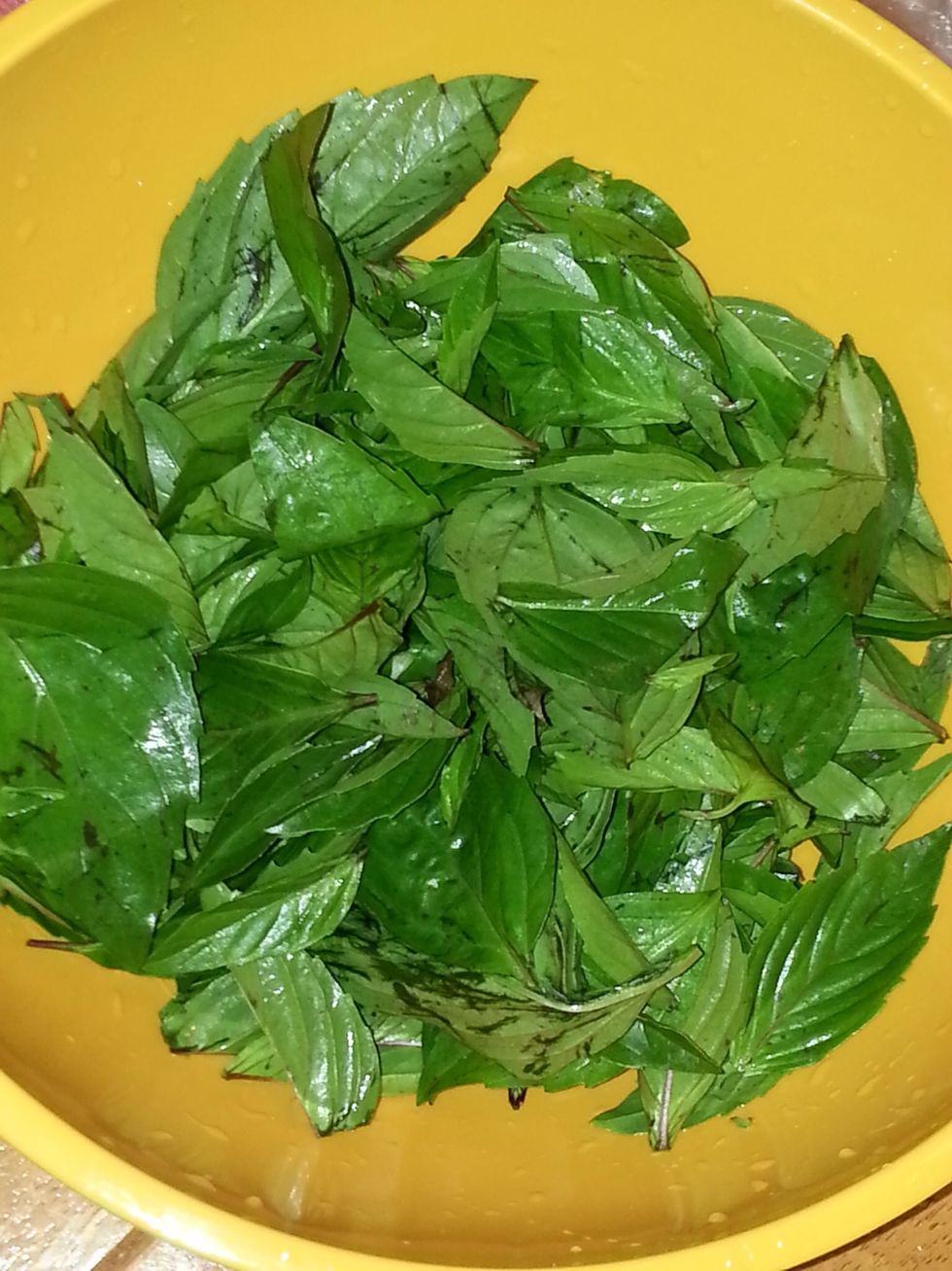 De-stem and mince the Thai basil, mint, and coriander.