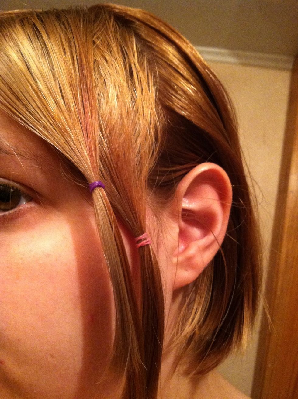 Decide hair into five sections and bind each one. The first one closest to your ear, bind at the middle of your ear and the one next to it one centimeter up. Like so.