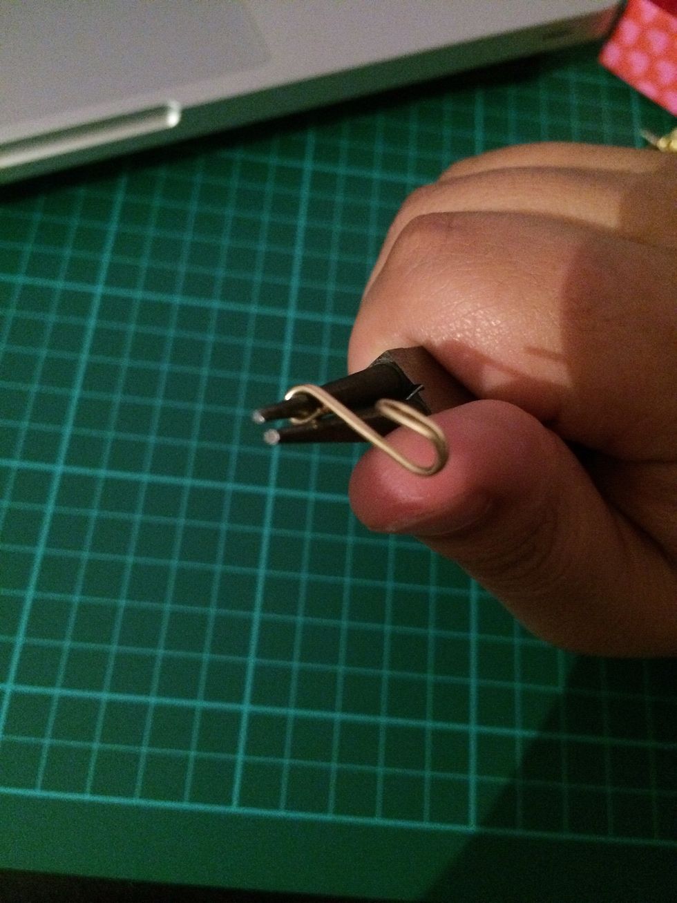 Decide how long you want your clasp to be and cut off the excess.  Wrap the non curved end of the clasp into a loop in the opposite direction of the hook.
