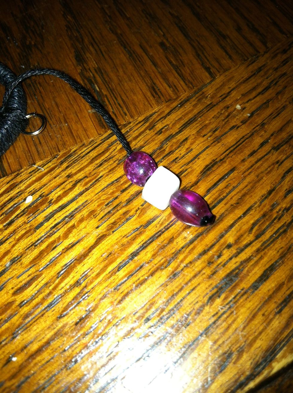 Decide on a length and tie an over hand knot. Snip it as close as you can and add s dab of glue. Do the same to the other side.