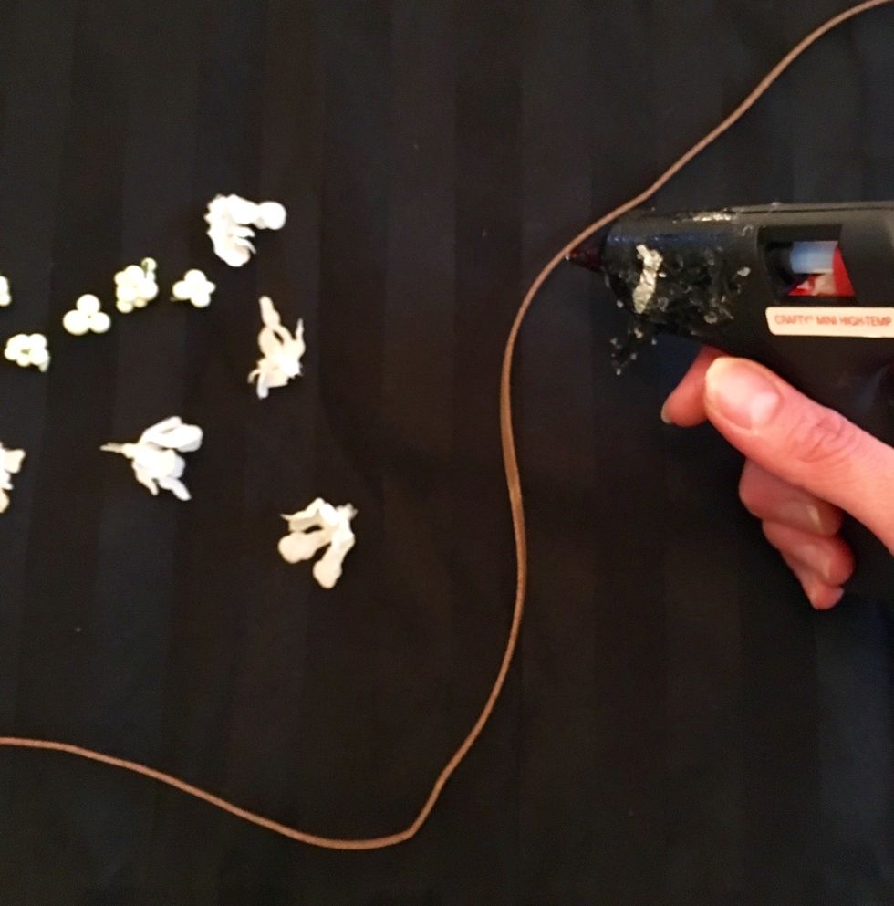 Decide placement of flowers, then hot glue on to strap.