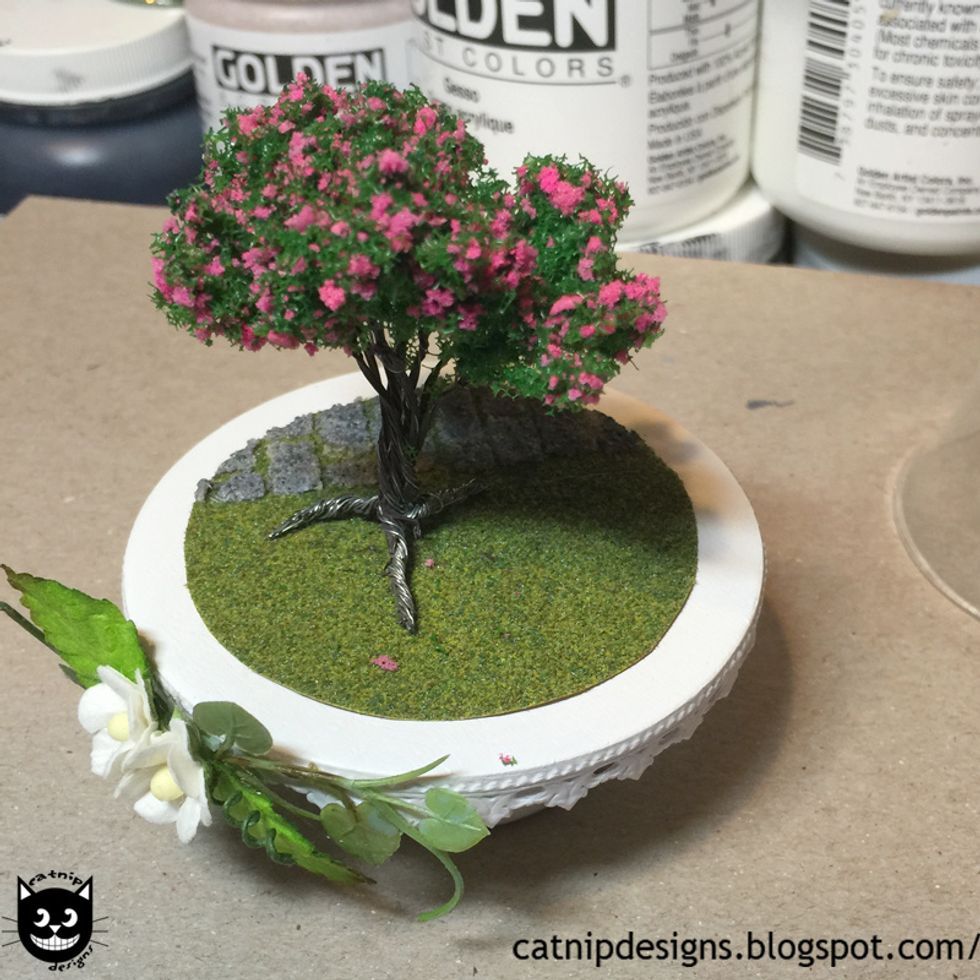 Decide where you will glue your tree to the grass.