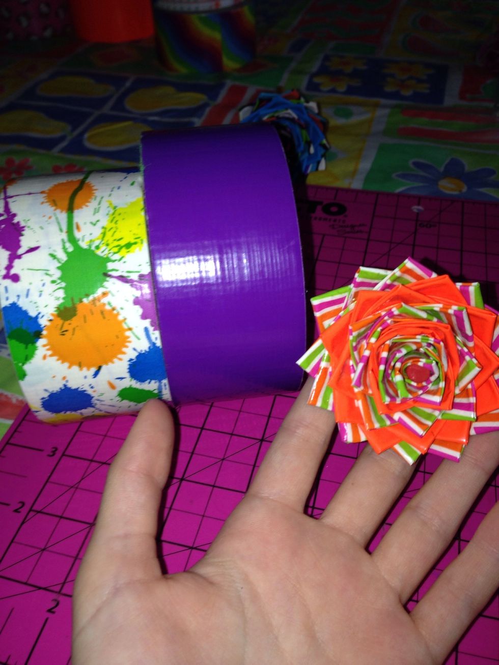 Decide which duck tape color you want the outside of your flower to be. Start the inside with the opposite color. (Ex. Out=purple, In=tie die)