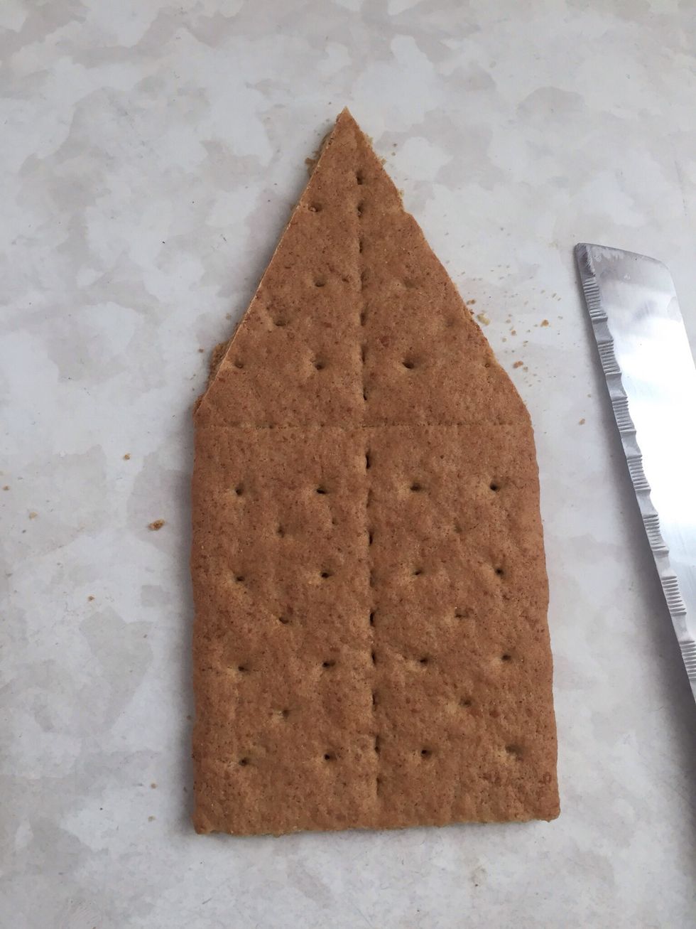 Decode on what you want your house to look like.  I found an idea on Pinterest.  Carefully cut crackers to shape.