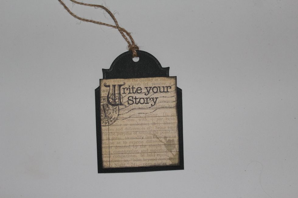 Decor the black tag with a Typography card and other embellishments and join to the burlap with Glossy Accent just in the bottom and decor the mini notebook guide too.