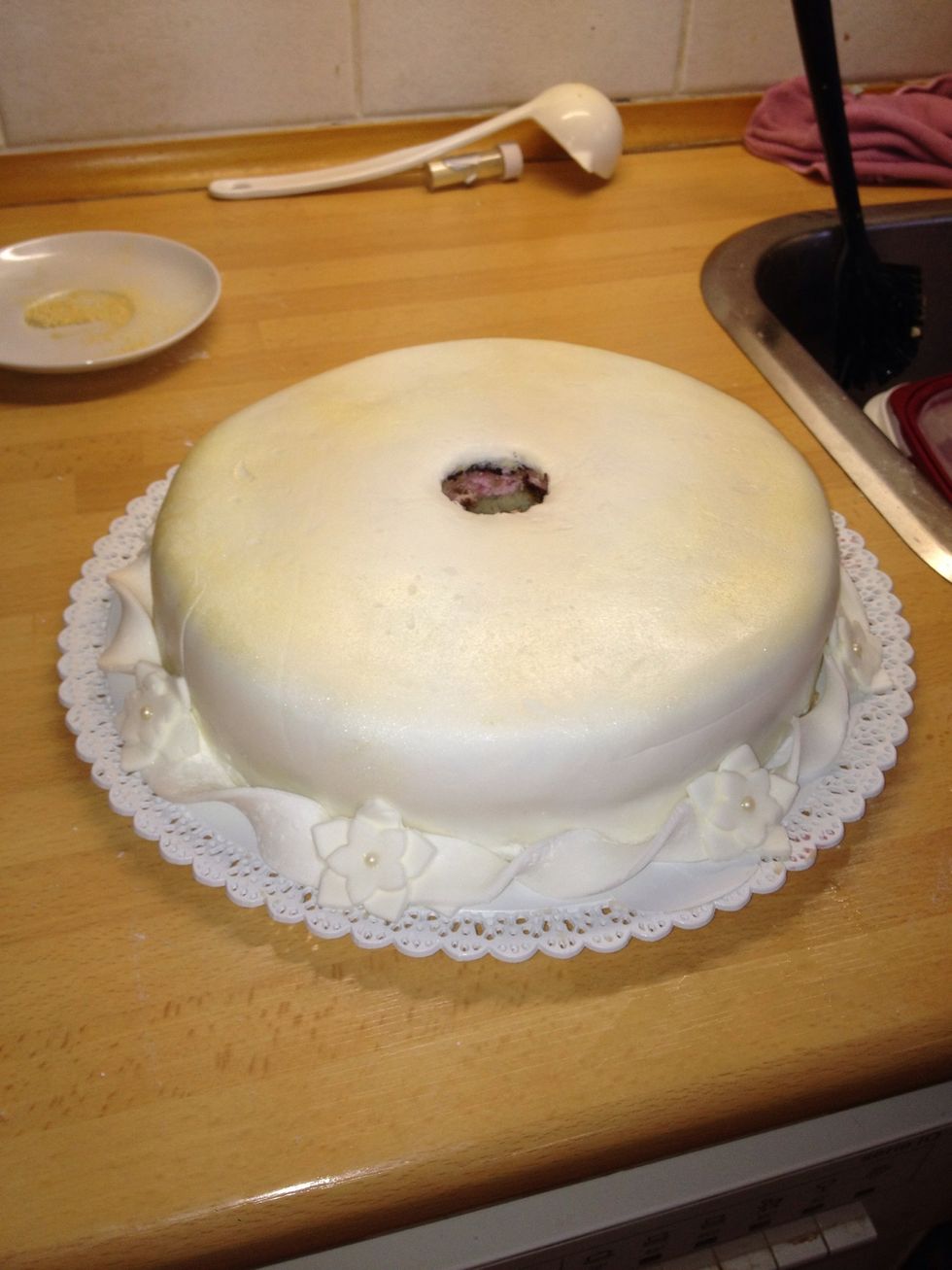 Decorate the cake and make another batch of fondant for the other cake. We cut a hole in the bottom cake in order to fit it in the rack.