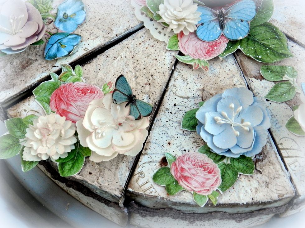 Decorate the cake with flowers, butterflies and bird.