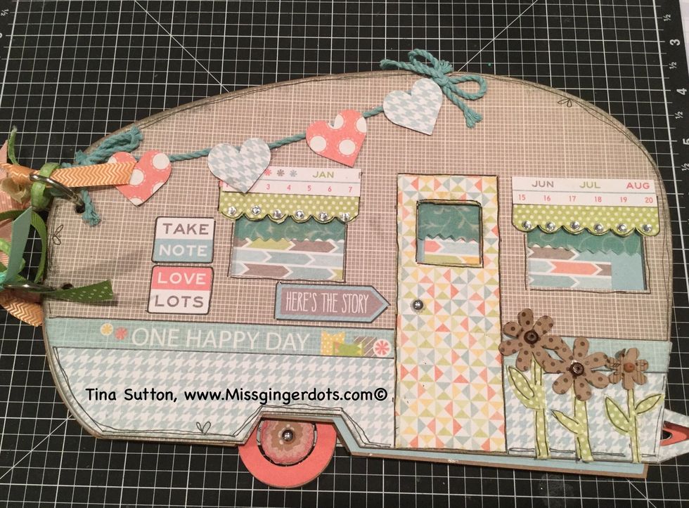 Decorate the front as shown First glue down the One Happy Day Zip strip across the grey and blue plaid. We will decorate the rest of the cover later.