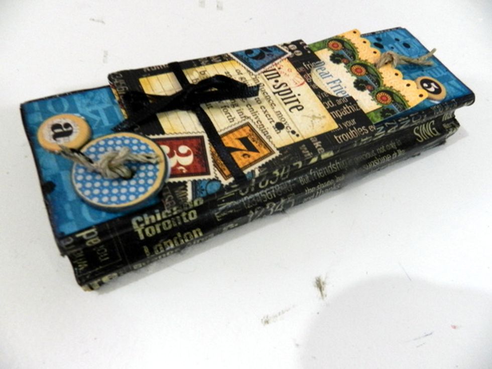 Decorate the top using the pocket with the tag, and the buttons and little letters.