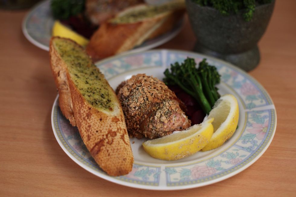 Decorate with your veges, garlic bread and a few slices of lemon and serve with a white wine. It should be juicy and tender and won't require a sauce. We're not done yet. Here comes the thigh...