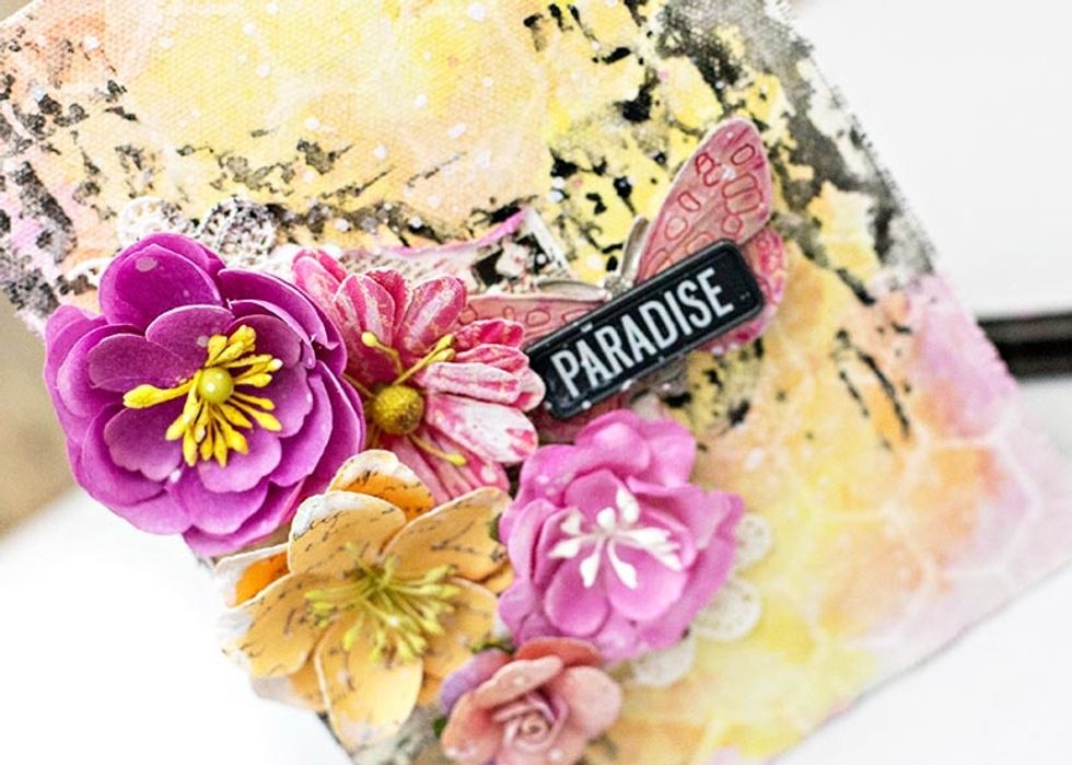 Decorate your canvas with a 3x4" card, a cluster of flowers, the Prima resin, a touch of trim, and a street sign to finish it off!