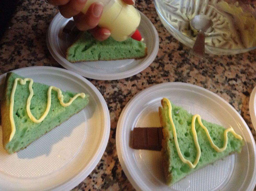 Decorate your Christmas trees with your yellow cream using a syringe.