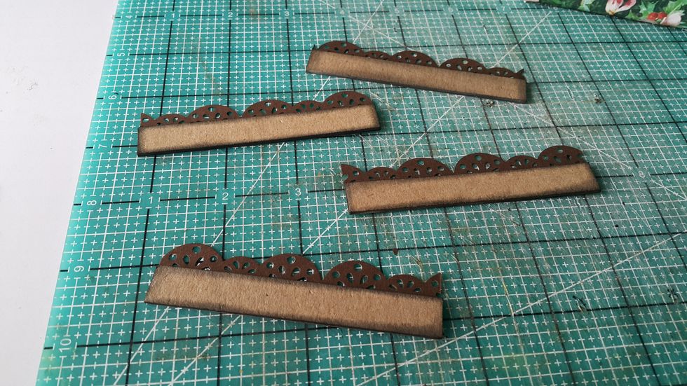 Decorating tip: use chipboard strips and cardstock punch-outs to decorate the house roof