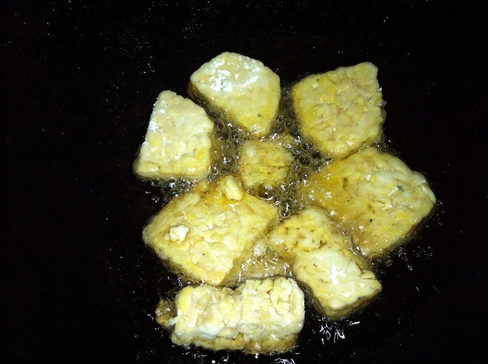 Deep fry the tempeh in hot oil. Drain and keep aside.