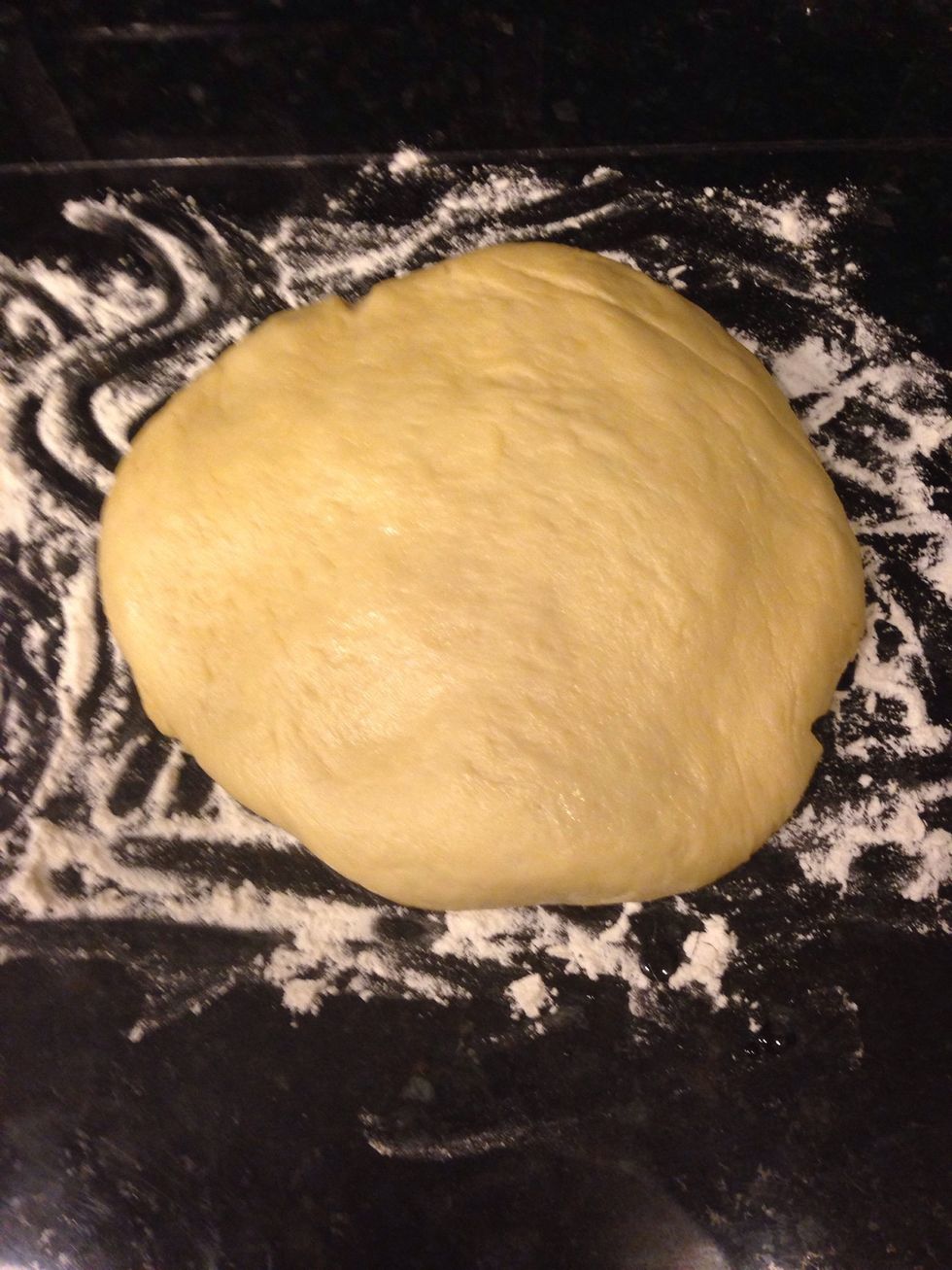 Deflate the dough and turn it out onto a lightly floured surface.