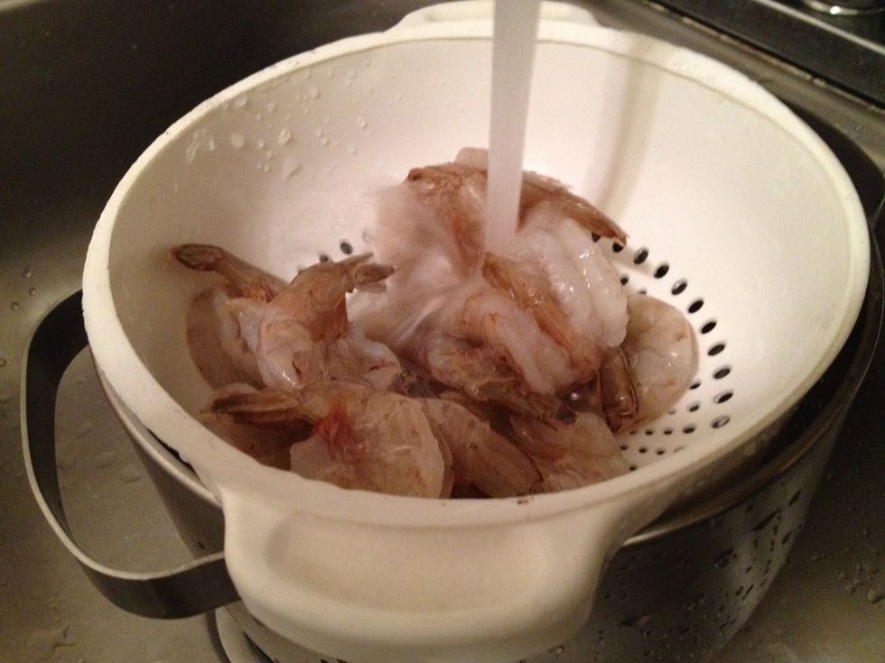 Defrost the shrimp by running them under cold water