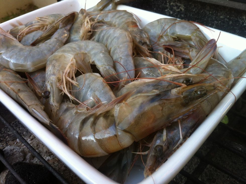 Defrost them if frozen,  in some cold water and some coarse salt