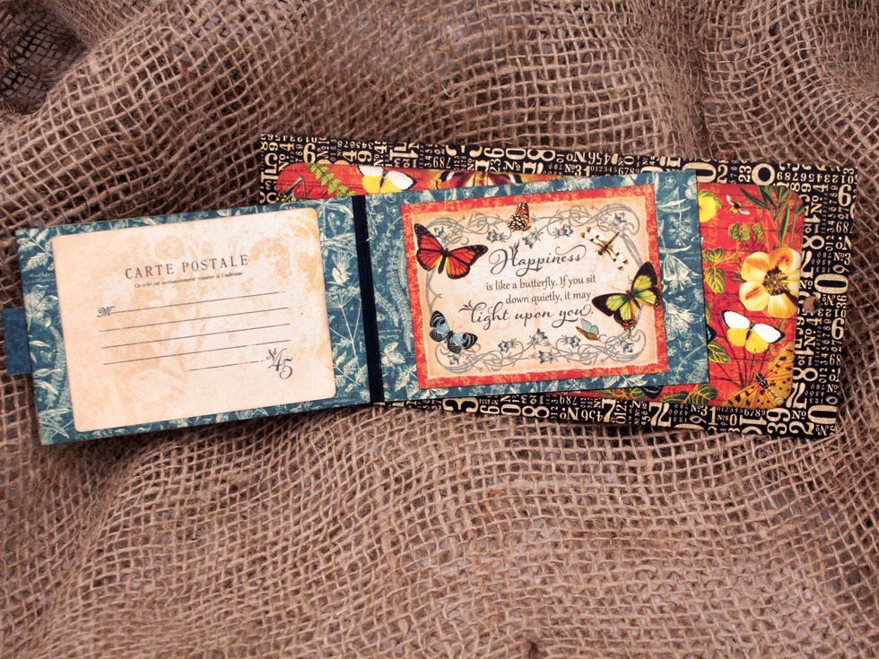 Deocrate the inside of the book with more cutaparts or ephemera cards.  Adhere to the front of the 2nd policy envelope.