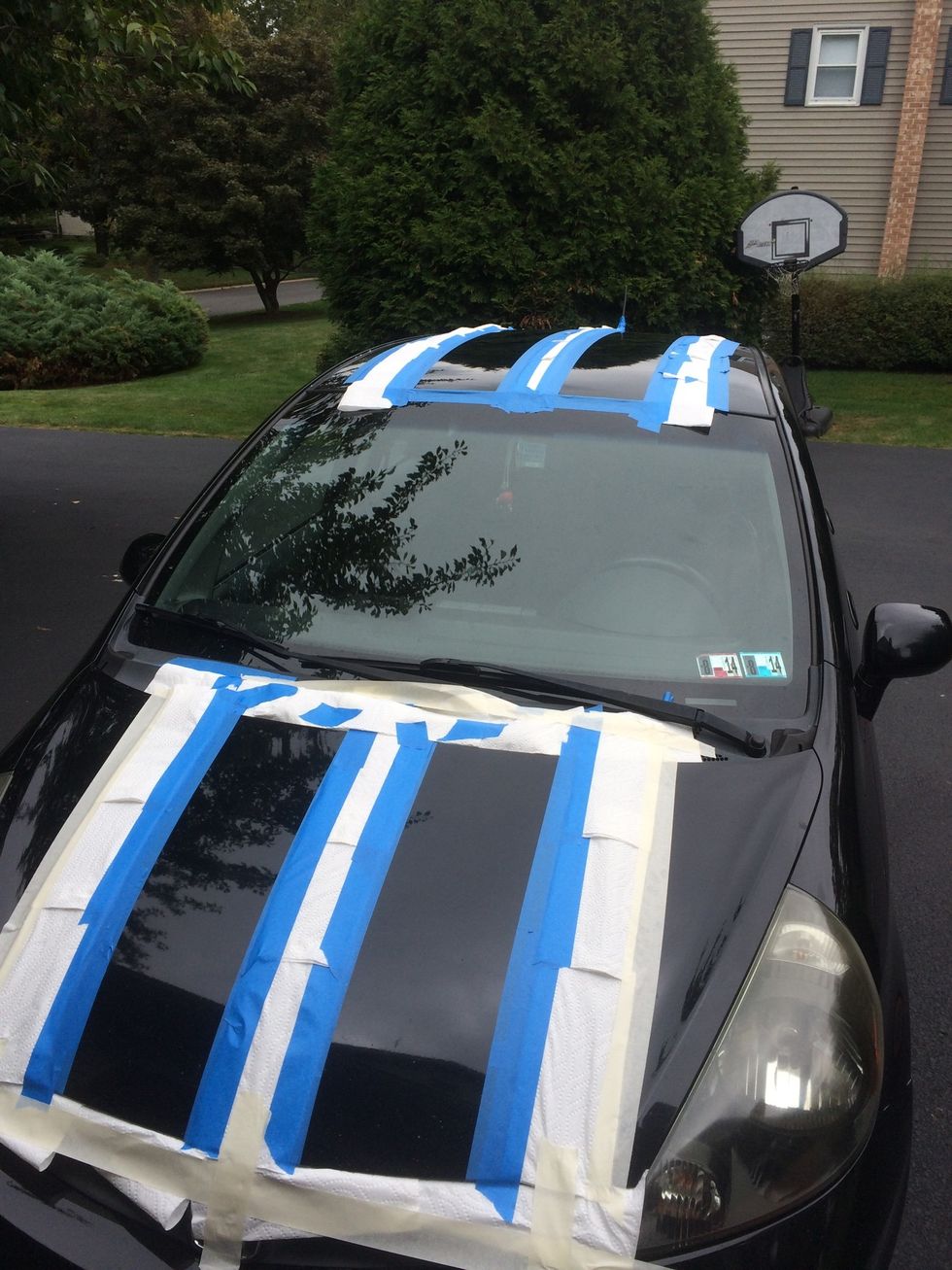 Depending on how experienced you are with a spray can, cover up spots around the lines with paper or paper towels including windows, lights, etc