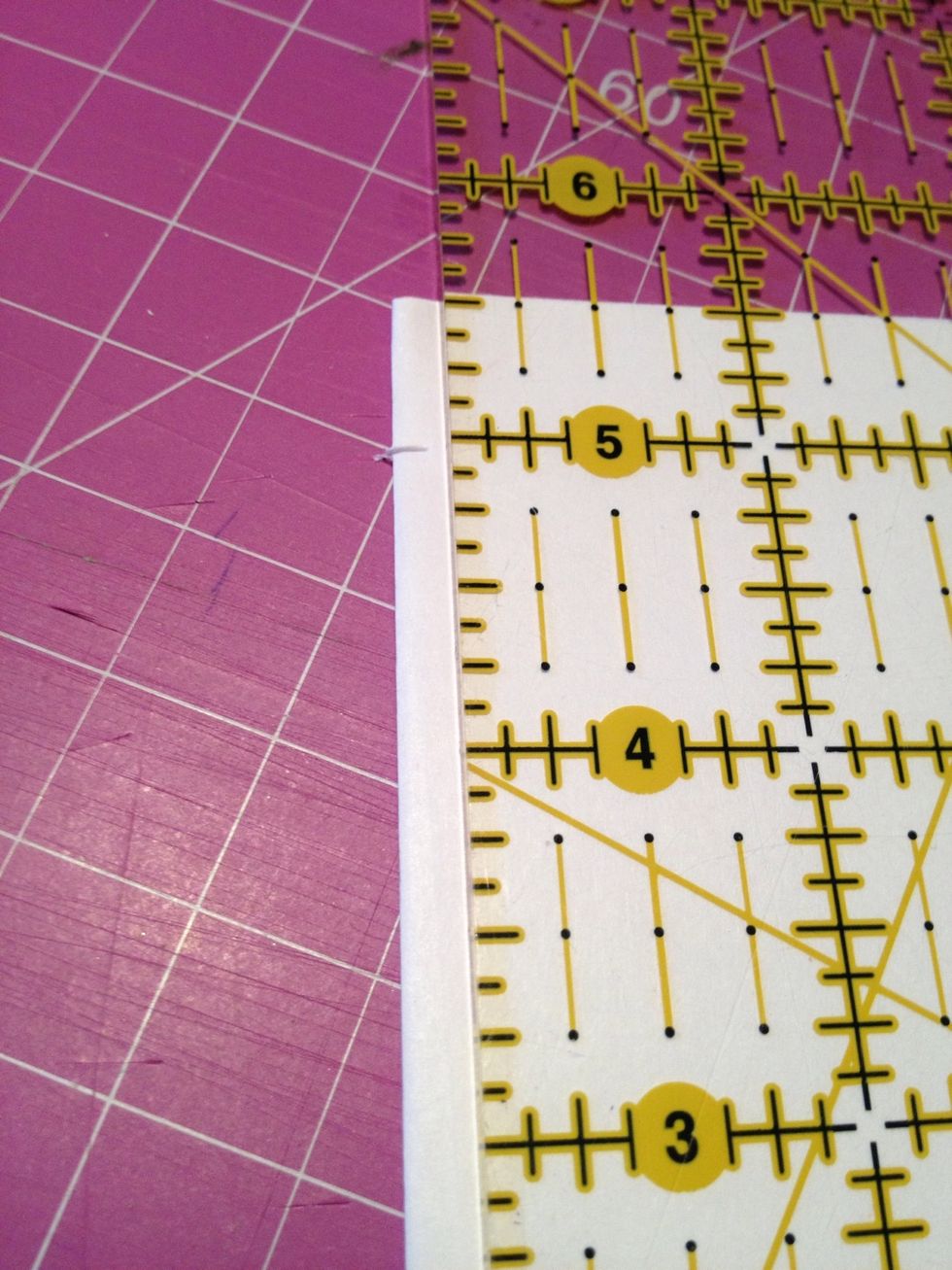 Depending on the size of your pages measure about half inch from each end. Then measure the space between your other marks halfway make your third mark. Using your knife cut a 1cm slit in spine.