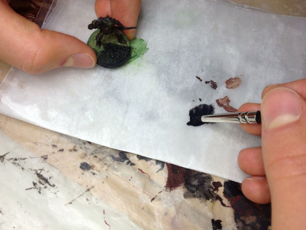 Depending on what primer you're using, watering it down slightly may help the primer to get into the recesses of the sand.