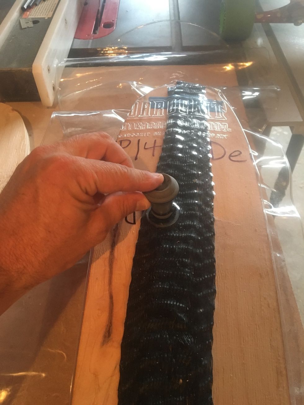 Depress valve to allow air into the vacuum bag.