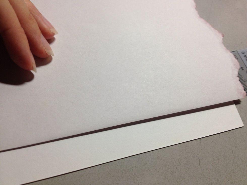Determine where you want the coloured paper to start and stop on the card, and fold over the paper accordingly. Cut the paper.