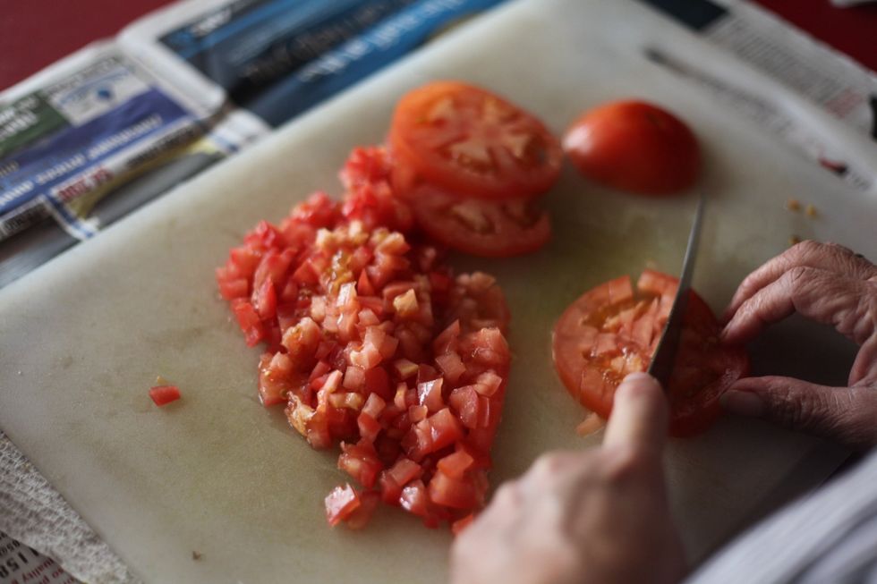 Dice 4 large tomatoes like so and add to your mixing bowl. Mum cuts with her left hand and writes with her right. Ambidextrous indeed...