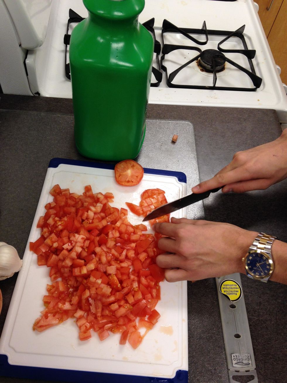 Dice all 4 tomatoes.