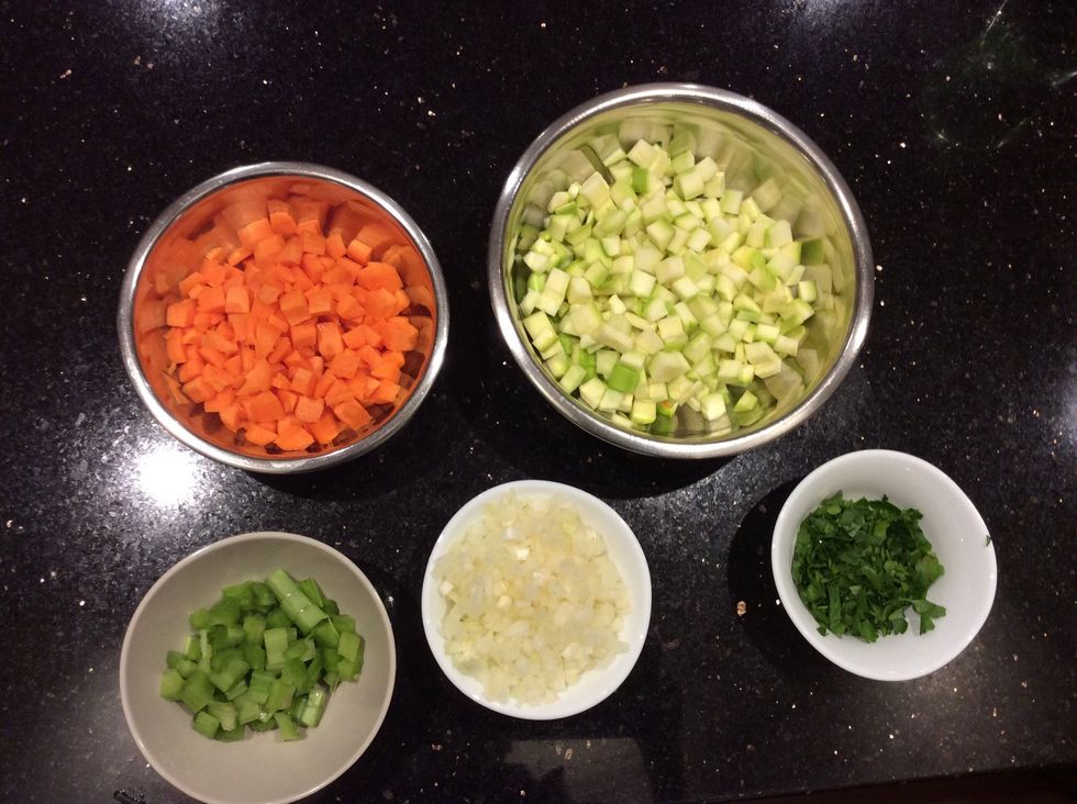 Dice all vegetables and herbs for cooking.