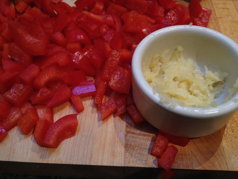 Dice the red peppers and mince the garlic cloves.
