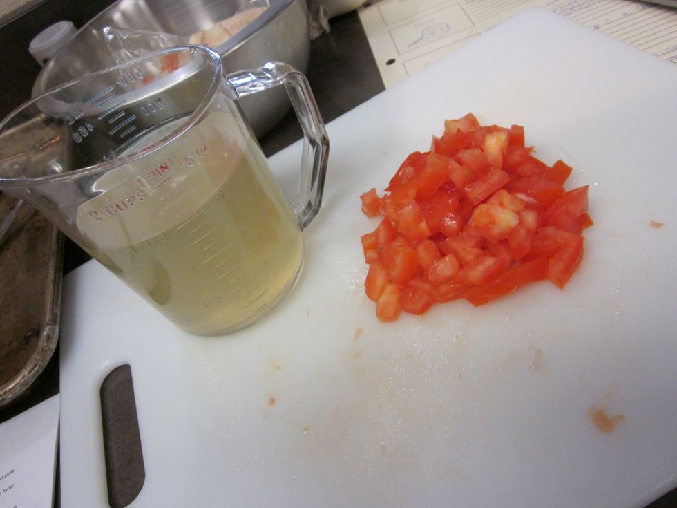 Dice the tomato and get a cup and a half of chicken broth.