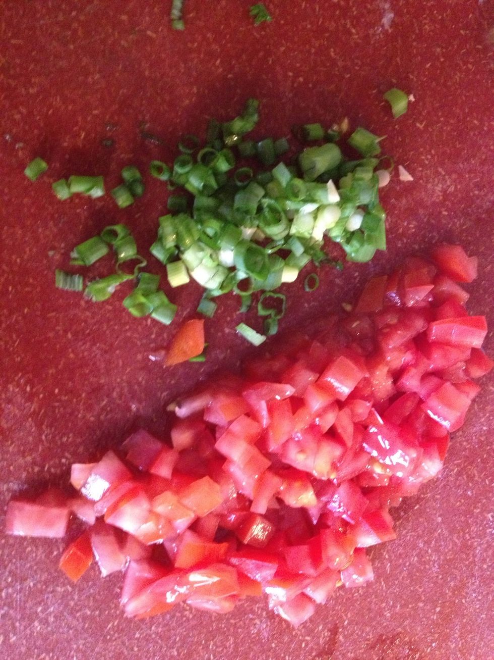 Dice the tomatoes and green onions.