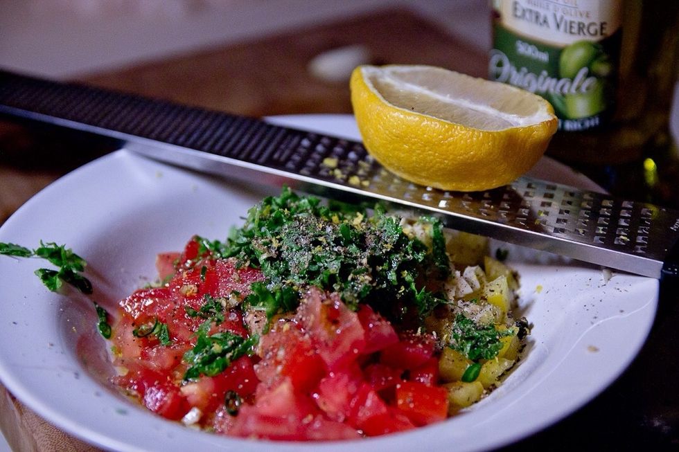 Dice your tomatoes and peppers. Chop your garlic and chili peppers. Chiffonade the cilantro and mix them all together with the olive oil and lemon. Season with salt an pepper and set aside.