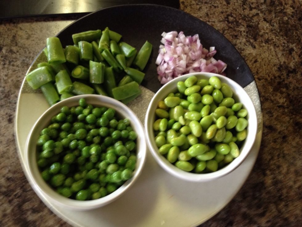Diced shallots, halved snap peas, thawed sweet peas, and shelled edamame.
