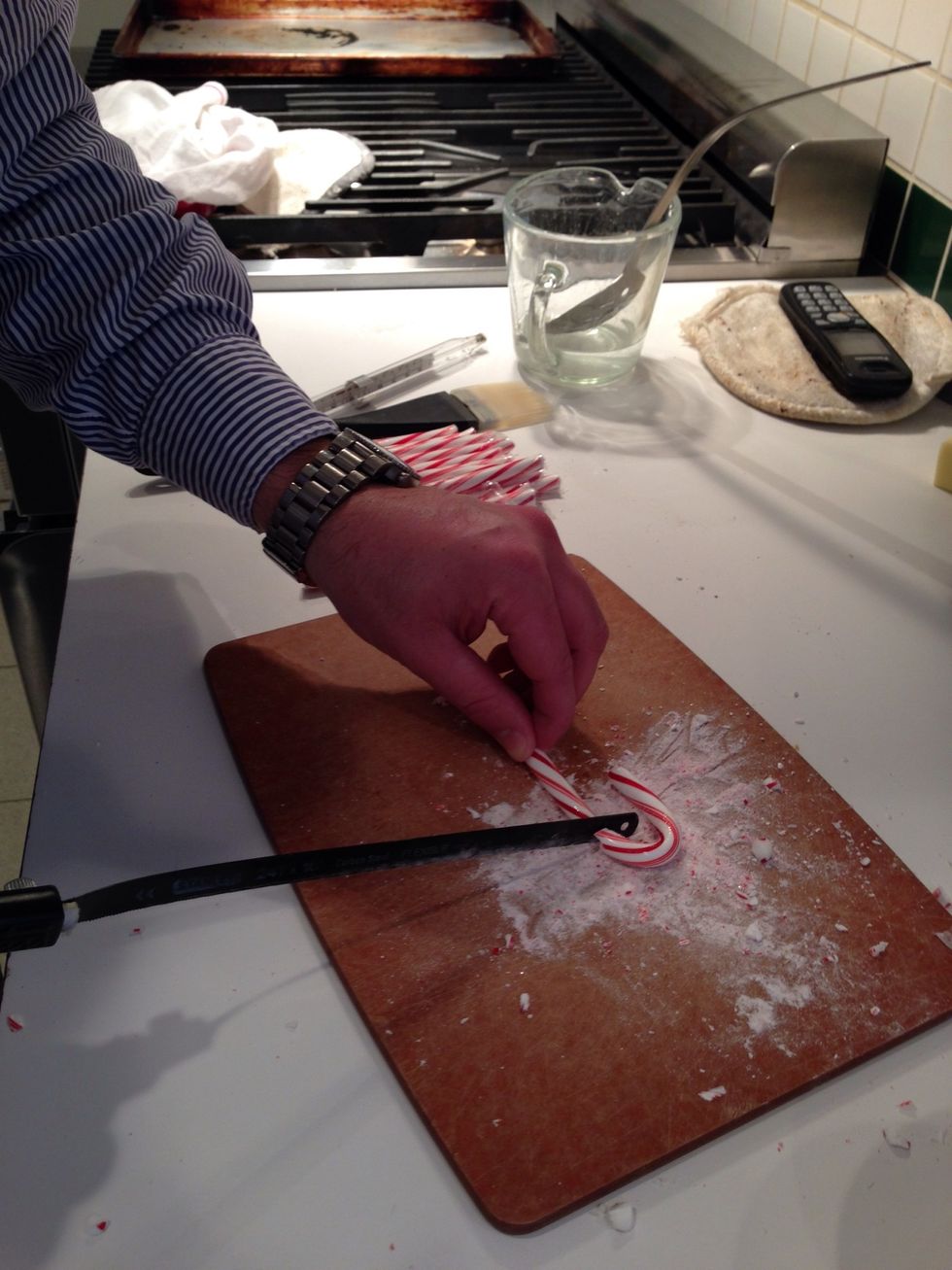 Did I mention the hacksaw? T. loves saws and is so happy I'm letting him use it in the kitchen. He is cutting candy canes to use as supports. No matter what, that dust will get on your floor.