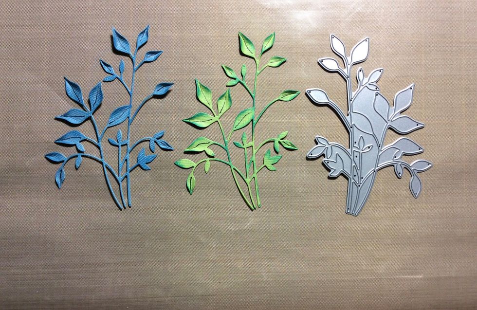 Die cut a leaf spray or similar in two coordinating card stock colours. Shape and ink each die cut. I used distress ink mermaid lagoon