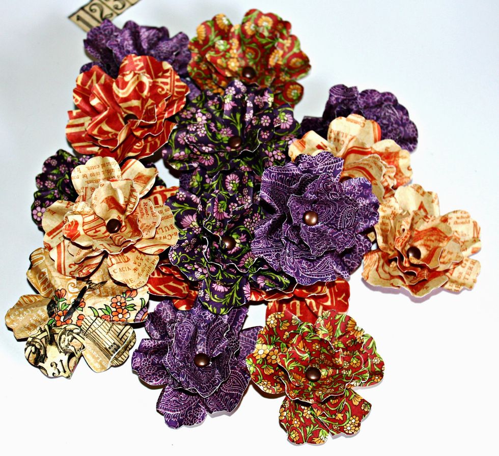 Die cut and create flowers using the Pansy Die. Shape petals with tweezers, place together using brad.