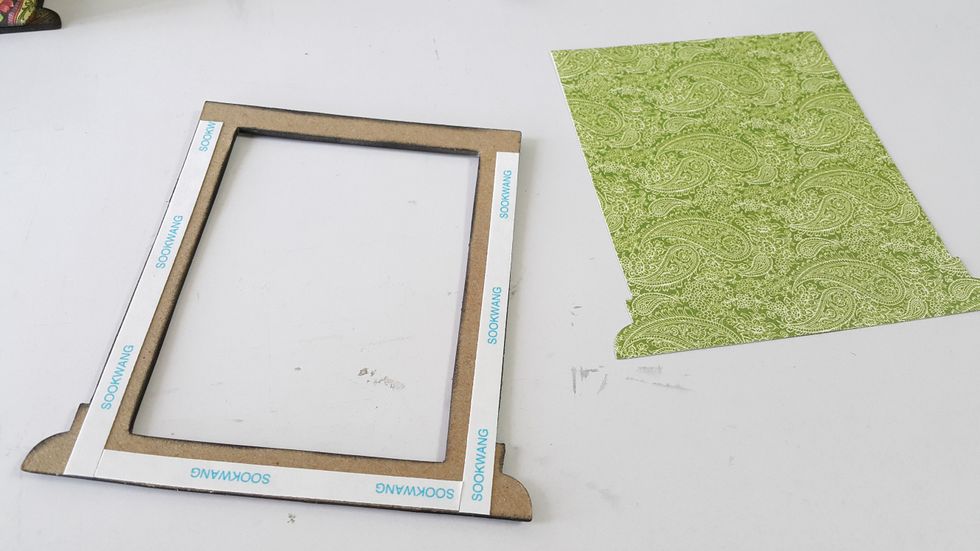 Die-cut another piece of pattern paper, adhere on the back of the window, cut the excess again